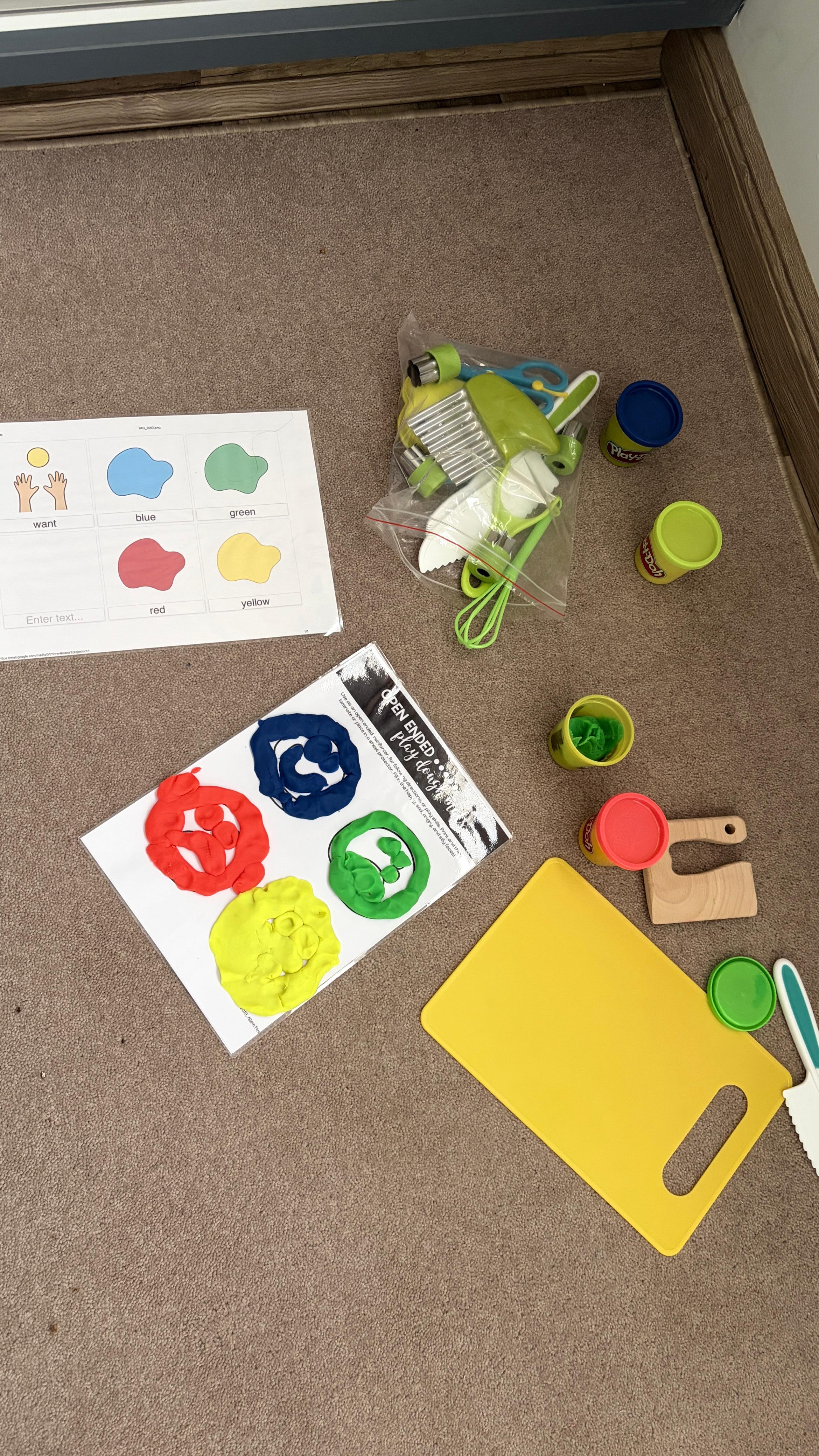 Play-Doh mats, colours, and tools set out for a therapy activity